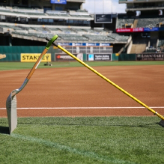 A rake and a shovel are seen on the field of the Oakland Coliseum prior to a baseball game between the Oakland Athletics and the San Francisco Giants on Friday, September 25, 2015.